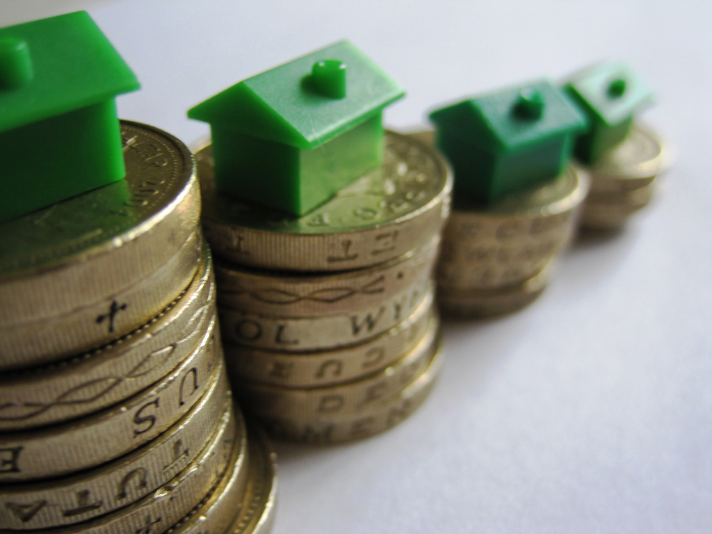 Piles of £1 coins with monopoly houses on top